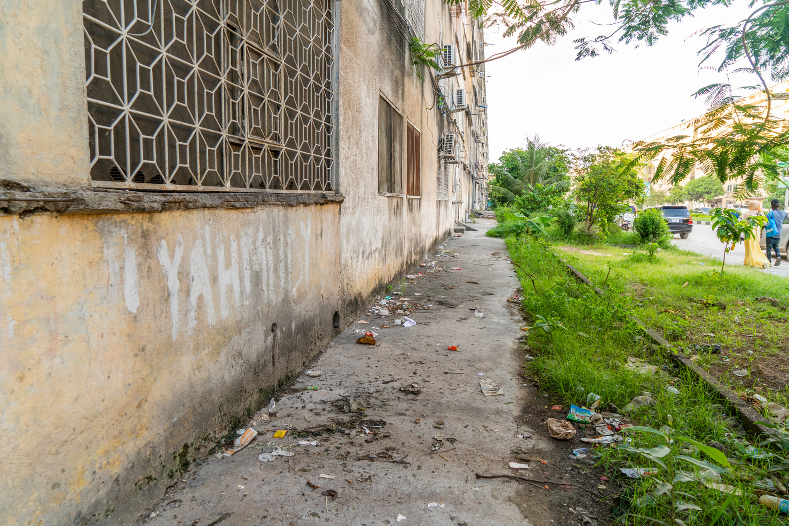 Dirty sidewalk along apartment blocks,  Zanzibar,  Tanzania